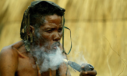 An elder smoking a traditional pipe