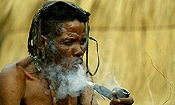 An elder smoking a traditional pipe