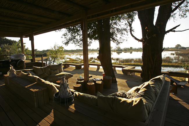 Lounge and view to the lagoon at Vumbura Plains