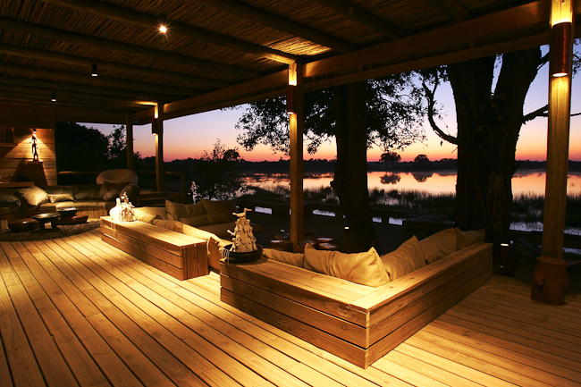 Sunset over the lagoon and lounge at Vumbura Plains camp
