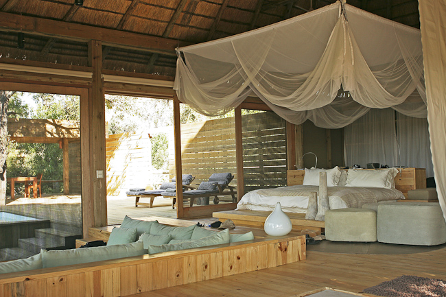 Guest bed, lounge and view to private deck