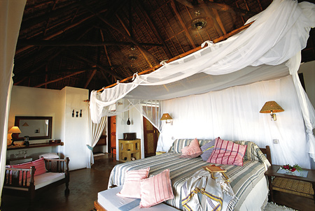Guest villas have a king-size bed with overhead fan and aircon
