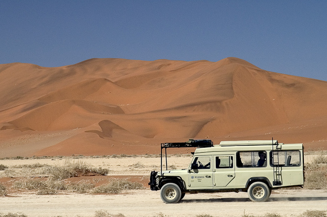Safari vehicle and dunes of Sossusvlei