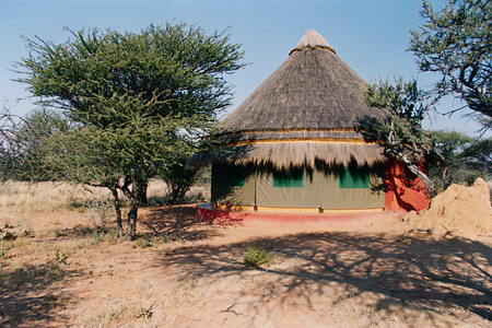 Thatched guest chalet, Okonjima Luxury Bush Camp, Namibia