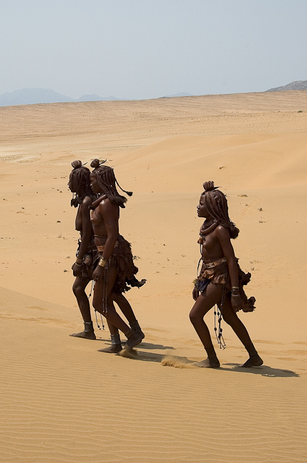 Himba crossing the sand at Serra Cafema