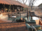 The lounge under thatch and pool at Puku Ridge