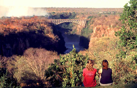 Guests looking onto the Victoria Falls Bridge from the hotel's lawn