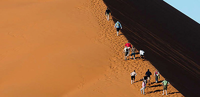 Climbing up "Big Ben" sand dune in Kulala Wilderness Reserve, Namibia