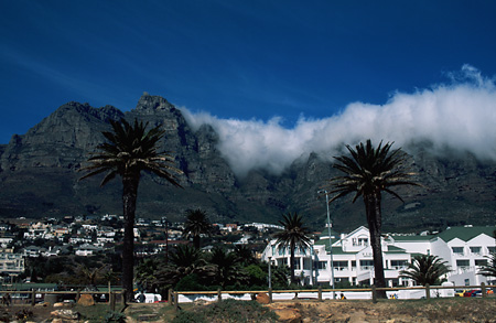 The lovely backdrop of the Twelve Apostles frames the beachfront Bay Hotel in Camps Bay, Cape Town, South Africa