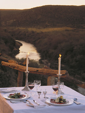 Kwandwe deck dining with sunsets over the river below