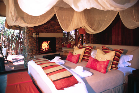 Makanyane guest suites include large beds and fireplaces