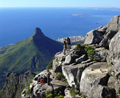 Rock Climbers on Table Mountain - Lion's Head and Robben Island in background