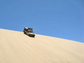 Driving down the sand dune